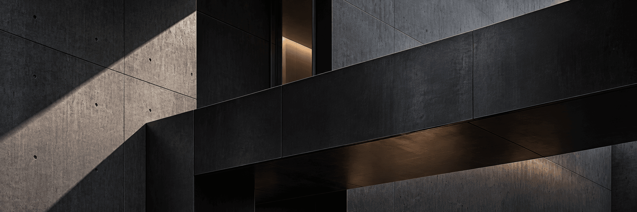 Architectural detail of a dark structural facade with restrained directional lighting.