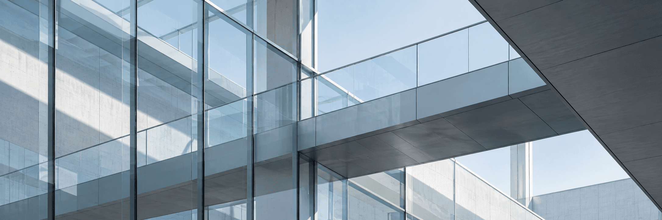 Architectural detail of intersecting glass and steel planes.
